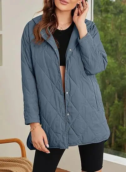 Woman wearing blue quilted hooded jacket outdoors