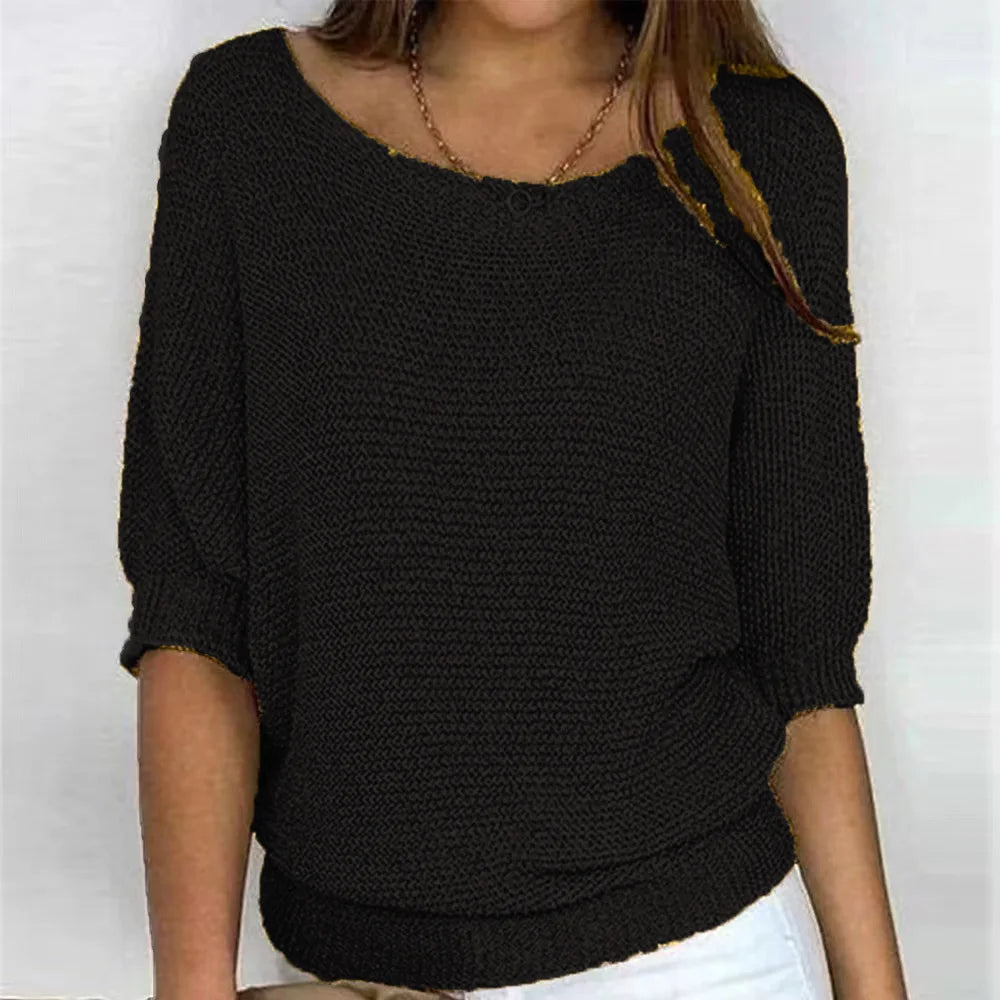 Black knit top with scoop neckline and three-quarter batwing sleeves