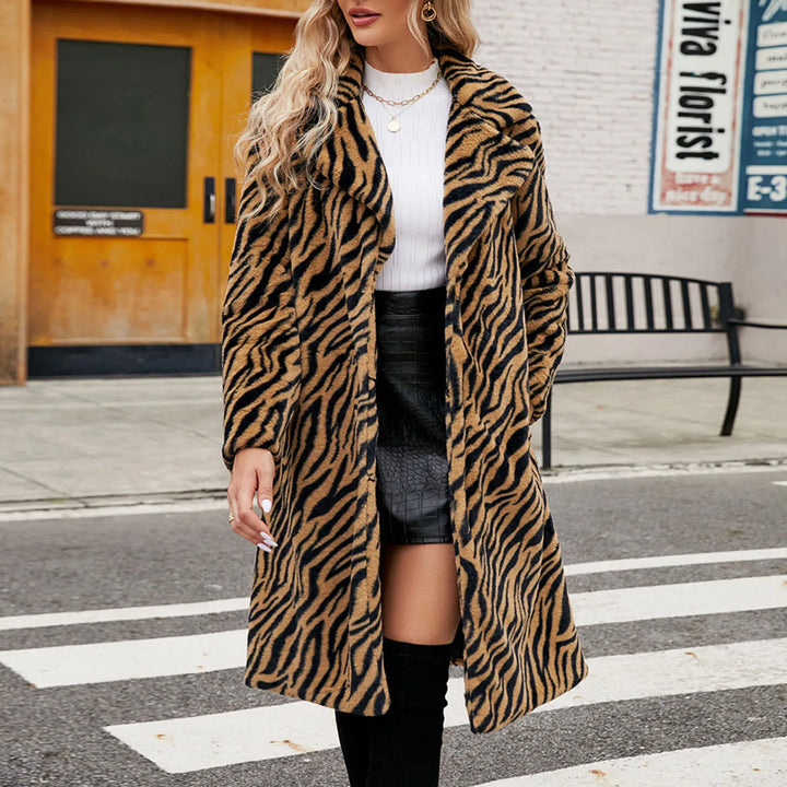 Woman wearing tiger stripe faux fur long coat on city street