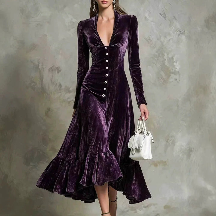 Woman in dark purple velvet midi dress with deep V-neck