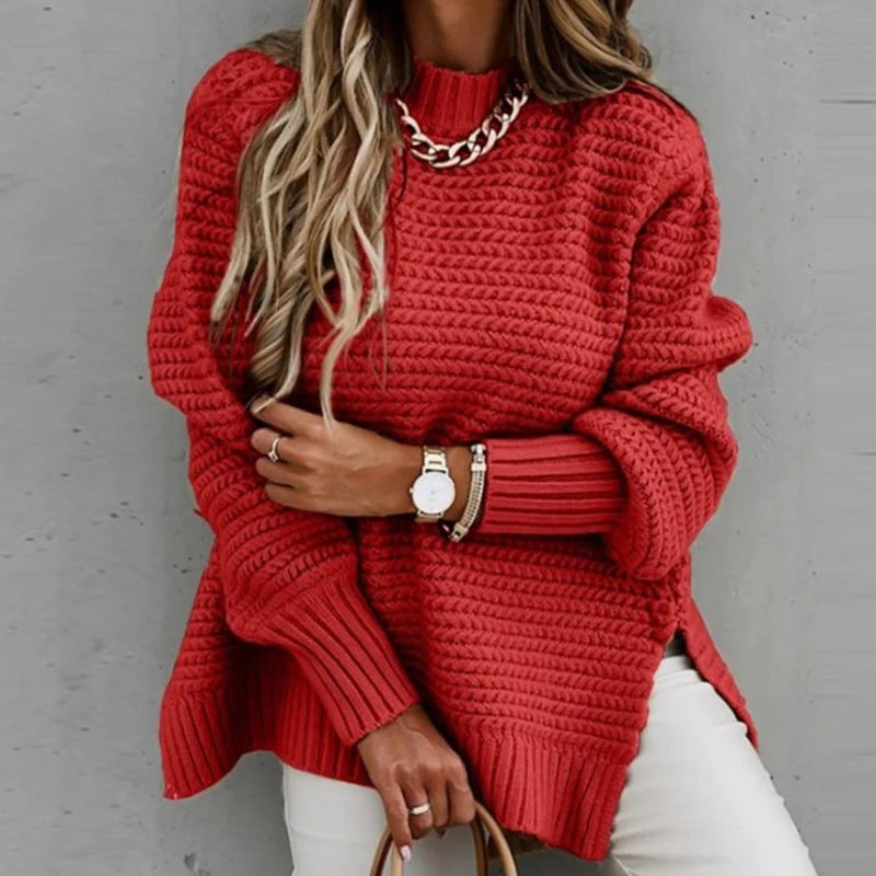 Woman wearing red chunky knit oversized sweater with mock neck