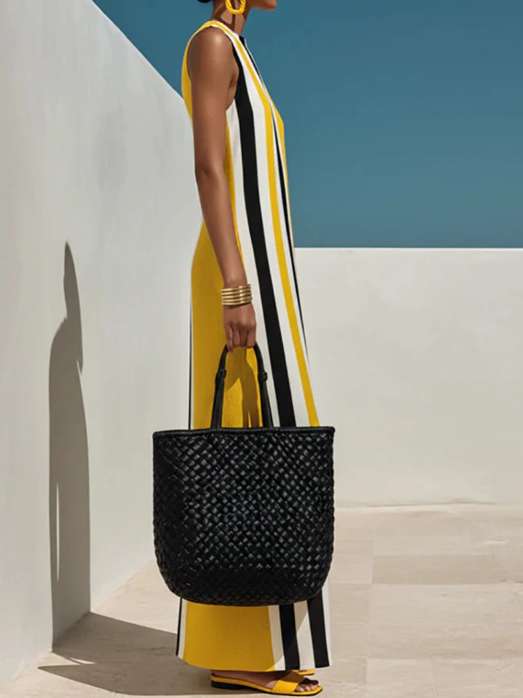 Side profile of yellow striped maxi dress