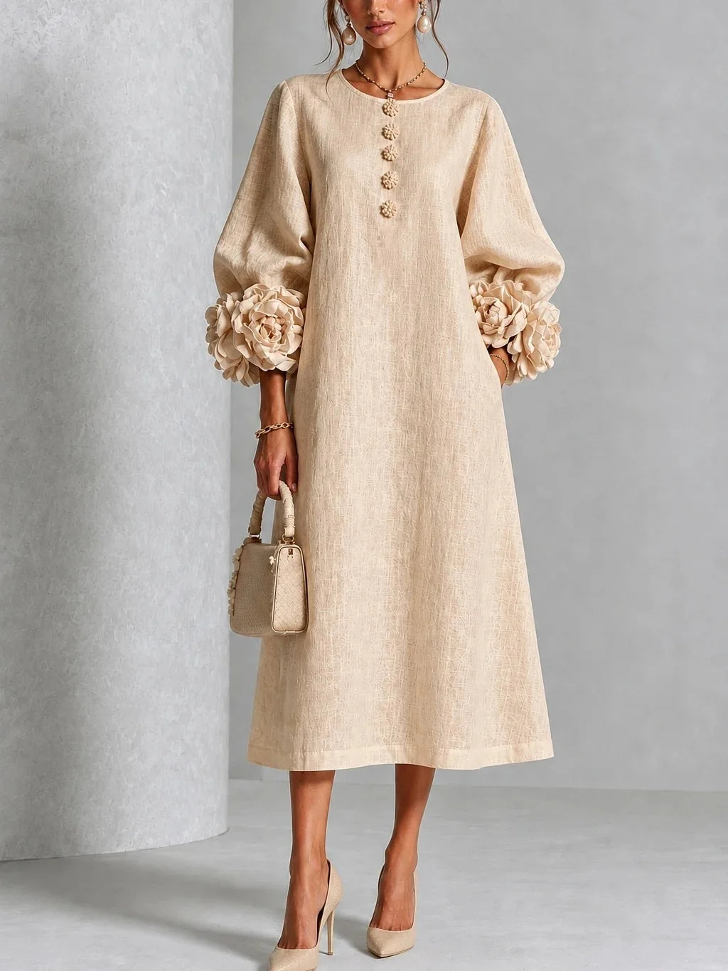 Woman wearing apricot midi dress with 3D floral lantern sleeve cuffs, front view