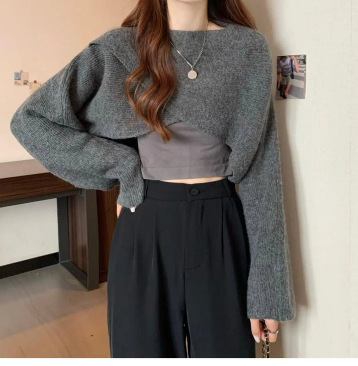 Model wearing gray crisscross wrap crop sweater with trousers