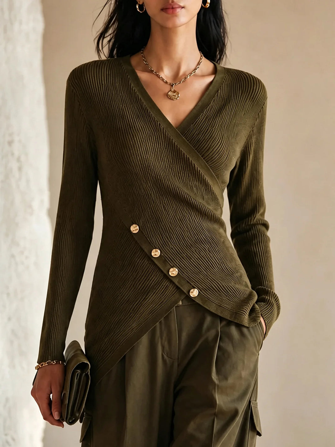 Close-up of olive green wrap-front ribbed knit top with gold button detail