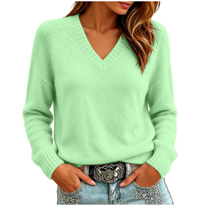 Woman wearing green oversized V-neck knit sweater with hands in pockets