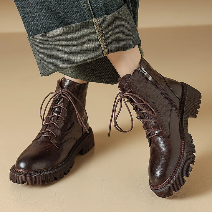 Pair of brown leather ankle boots with jeans cuffed
