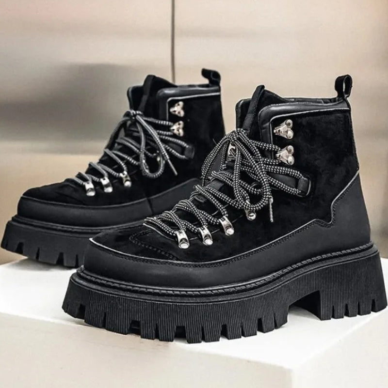 Black platform hiking boots pair on white surface
