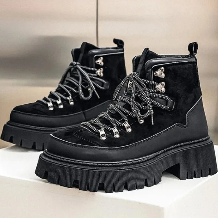 Black platform hiking boots pair on white surface