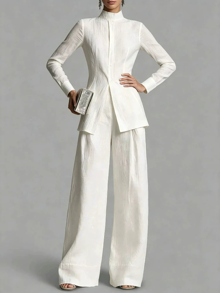 Close up of white mock neck top with button placket and wide leg pants