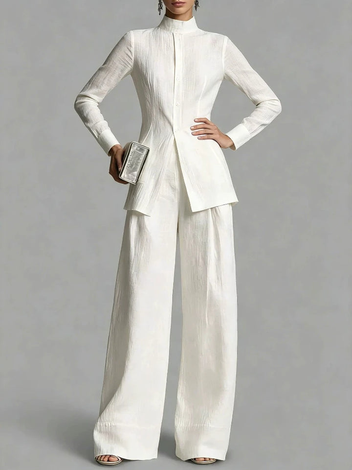 Close up of white mock neck top with button placket and wide leg pants
