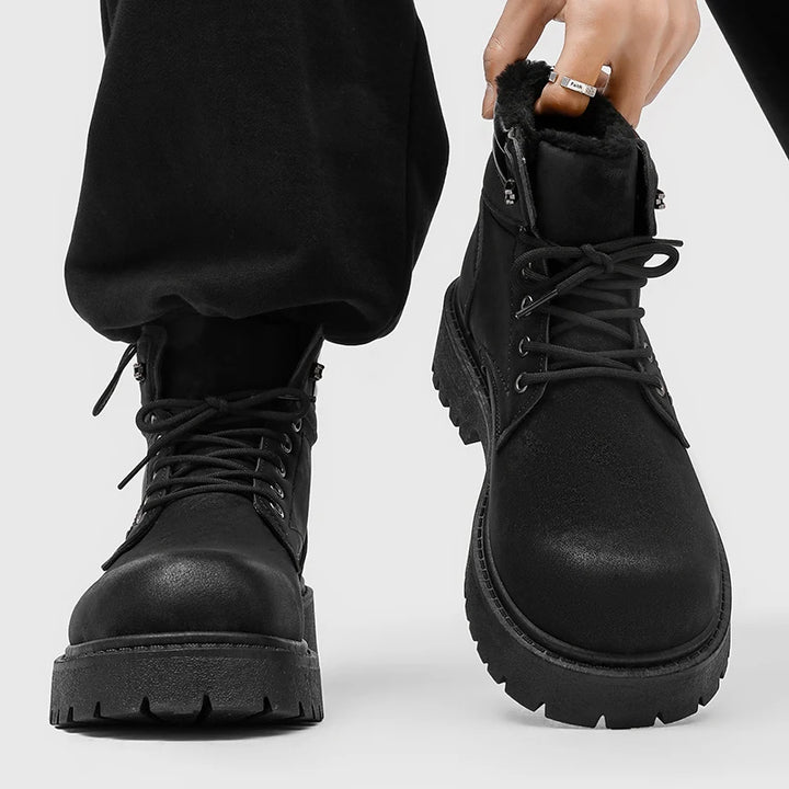 Man wearing black lace-up boots with plush lining