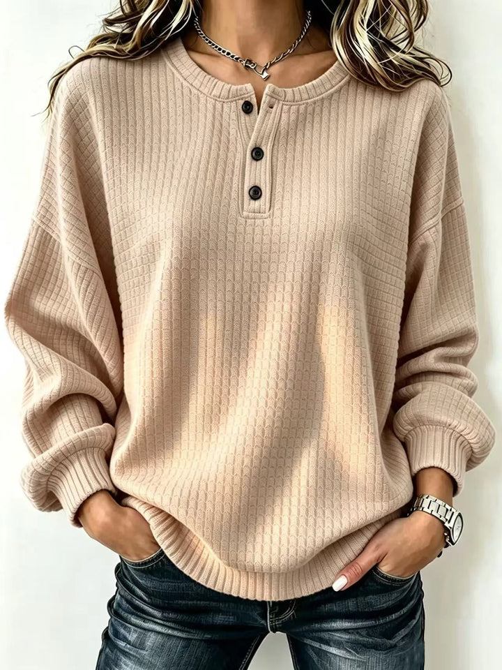 Woman wearing khaki waffle knit henley sweater