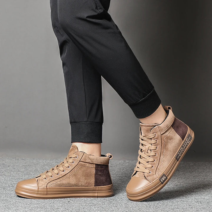 Model wearing tan high-top sneakers side view
