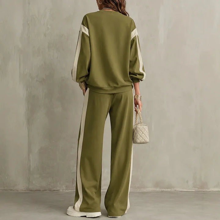 Woman wearing olive green two piece sweatshirt and pants set, back view