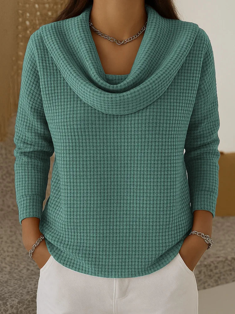 Woman wearing teal waffle knit cowl neck top