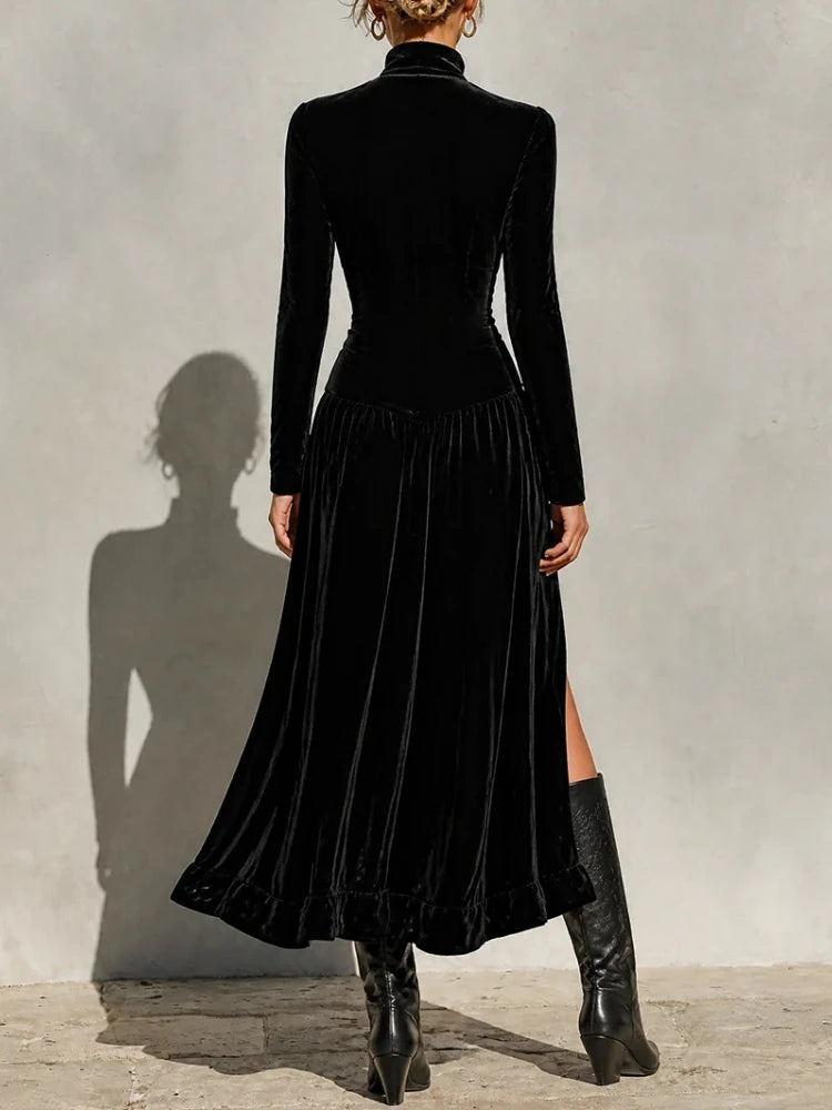 Back view of black velvet maxi dress with high split