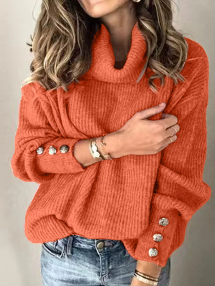 Woman wearing brick red ribbed turtleneck sweater with button cuffs