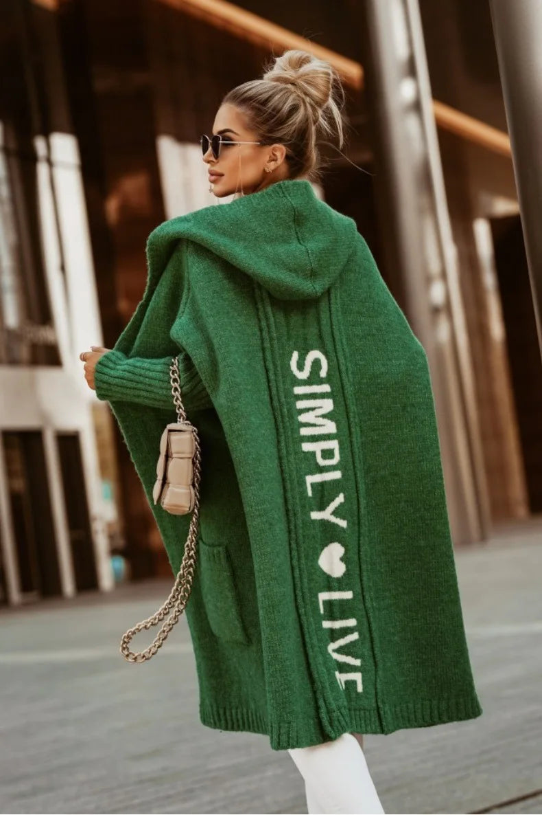 Back view of green cardigan with knit lettering graphic