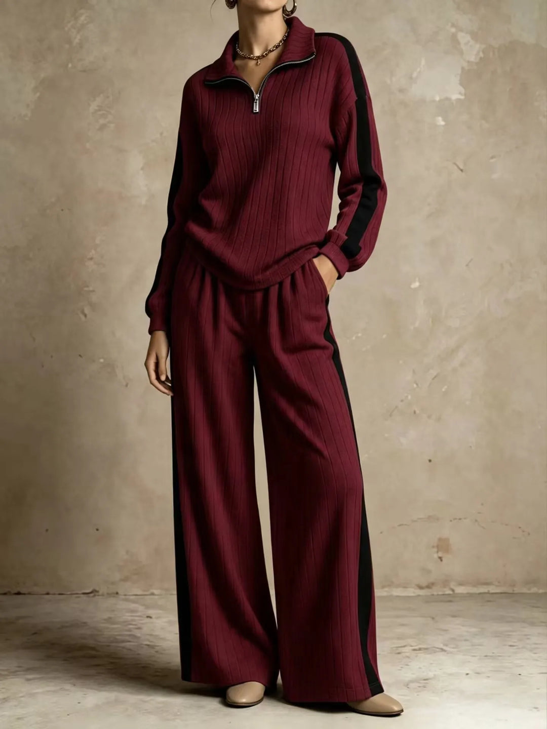 Woman wearing burgundy ribbed knit two piece set with black side stripe