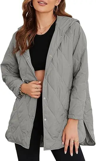 Woman wearing gray quilted hooded jacket, close front view