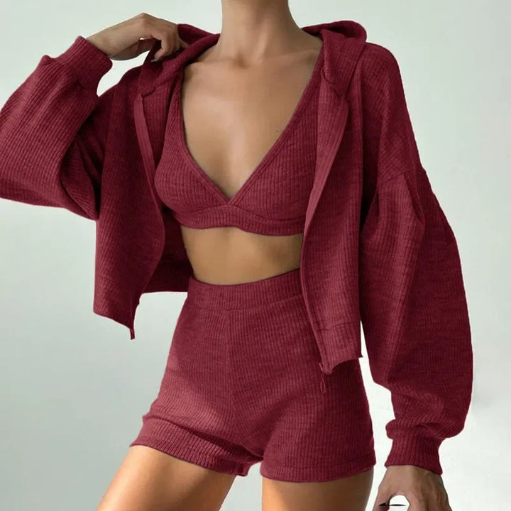 Woman wearing wine red ribbed knit hoodie and shorts set with hood pulled up