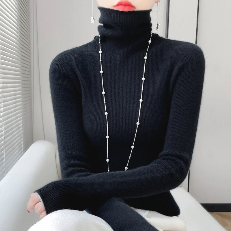 Woman wearing black ribbed turtleneck sweater with pearl necklace