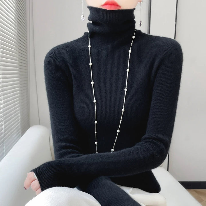 Woman wearing black ribbed turtleneck sweater with pearl necklace