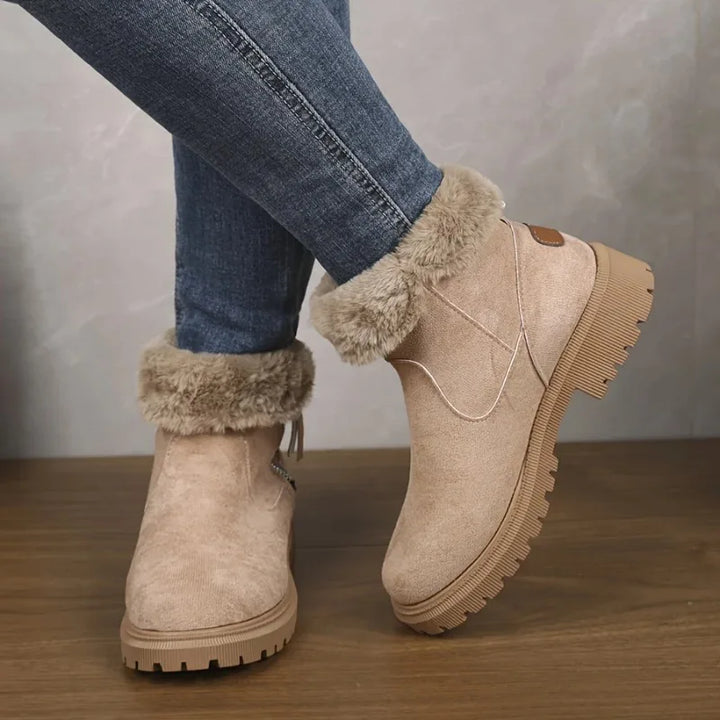 Woman wearing khaki suede snow boots with faux fur cuff