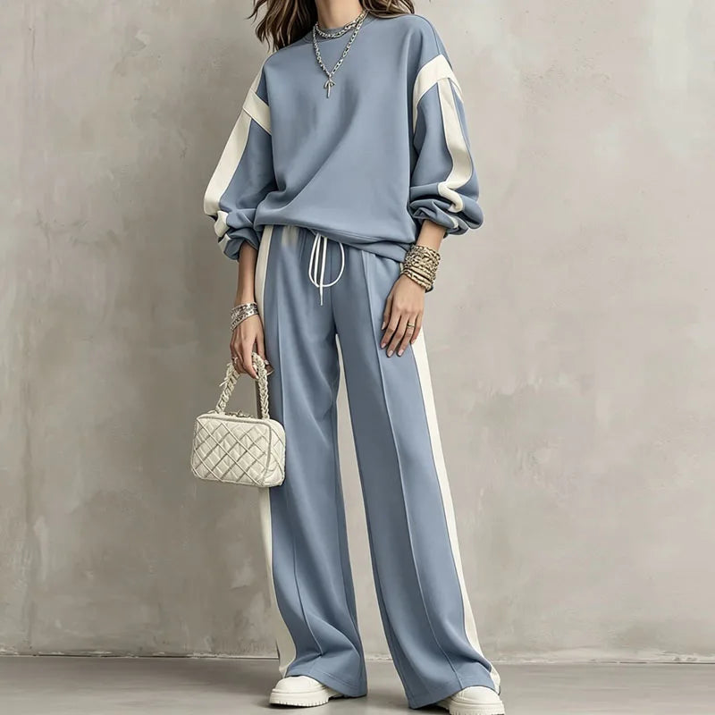 Woman wearing blue color block sweatshirt and wide leg pants set, front view