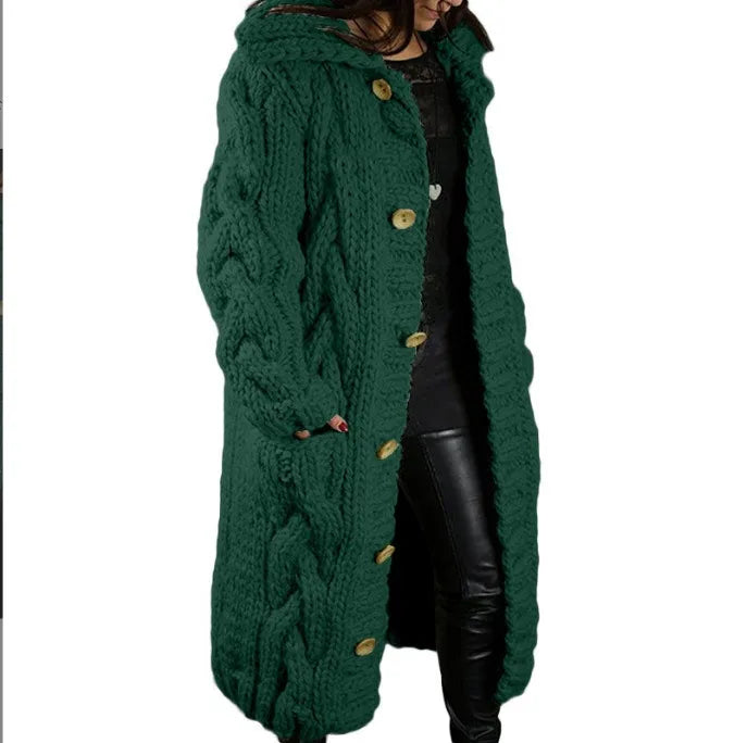 Woman wearing green hooded cable knit long cardigan, front angle
