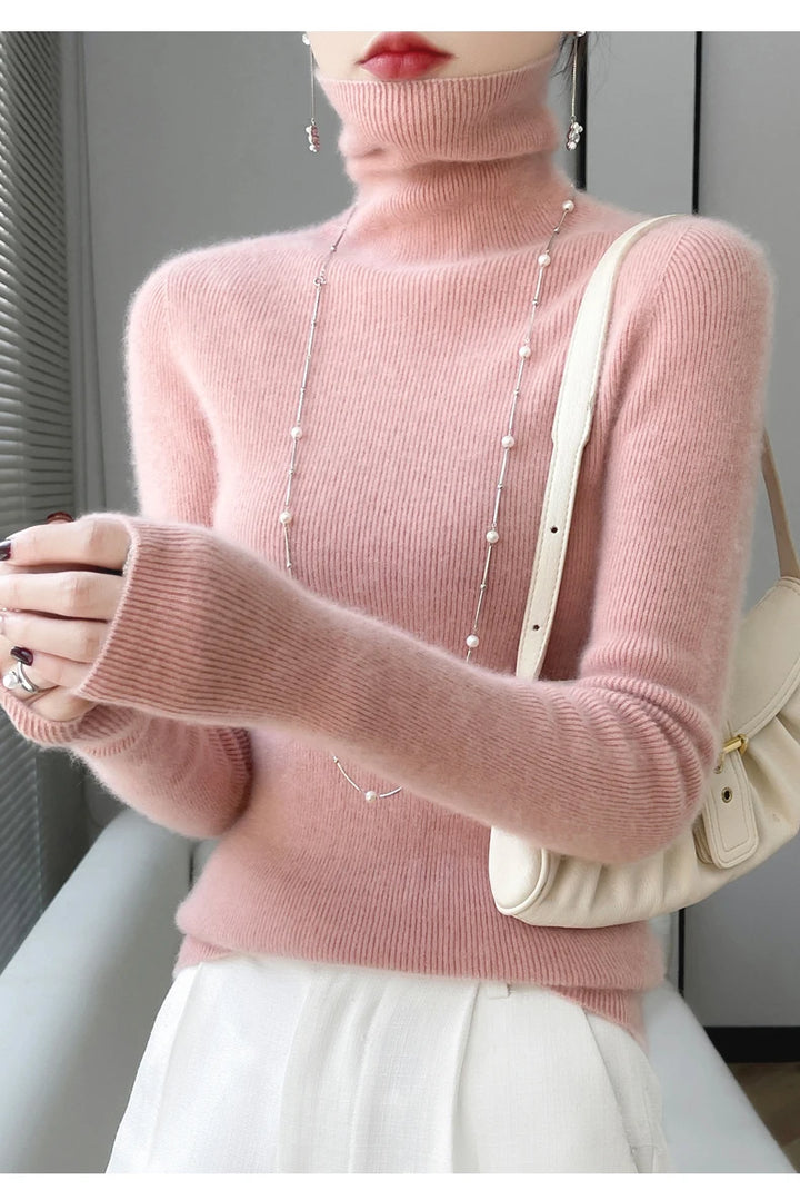 Woman wearing pink ribbed turtleneck sweater with pearl necklace
