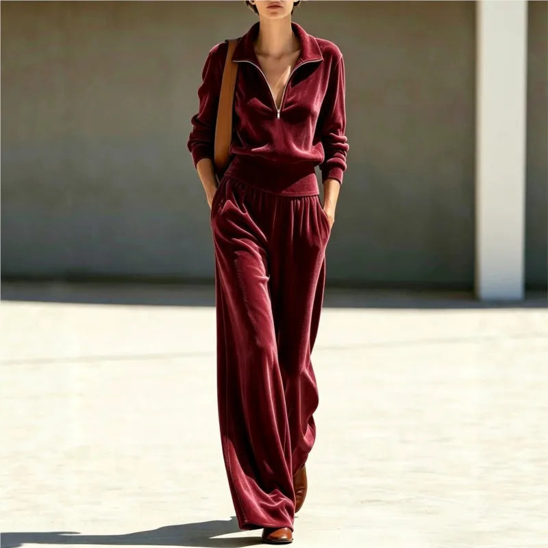 Woman wearing claret velour half-zip top and wide leg pants set, front view walking