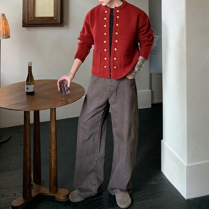 Man in red knit cardigan paired with wide leg pants, full outfit view
