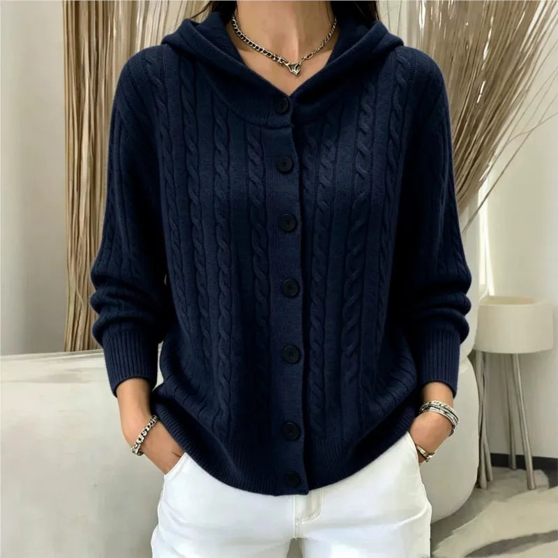 Woman wearing navy blue cable knit hooded cardigan