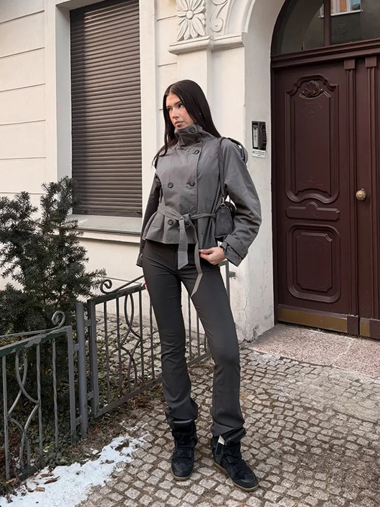 Woman wearing grey cropped trench coat with wide leg pants and sneakers