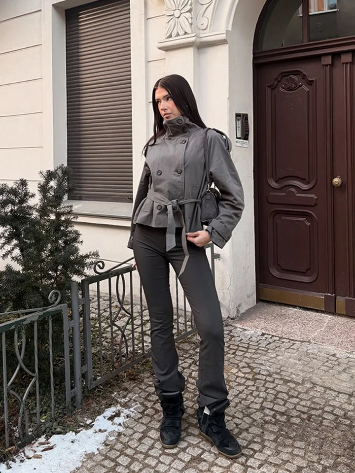 Woman wearing grey cropped trench coat with wide leg pants and sneakers