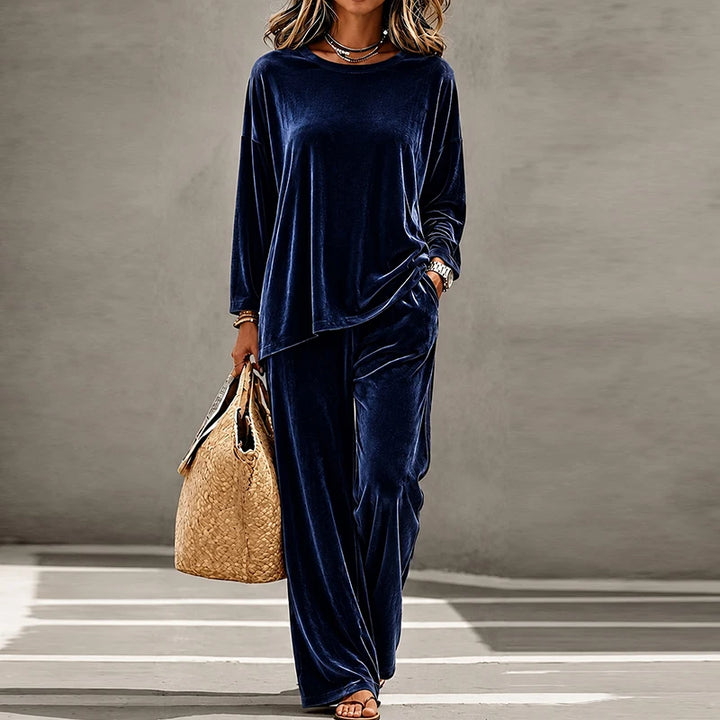 Woman wearing navy blue velvet two piece pants set