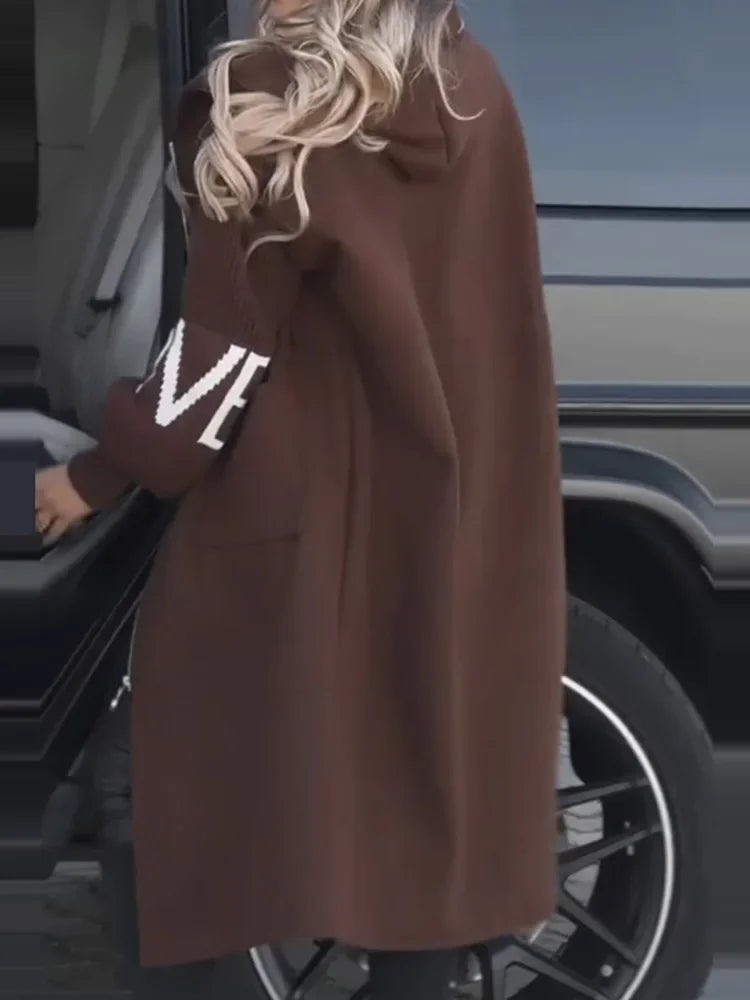 Back and side view of brown hooded maxi coat with contrast knit sleeve