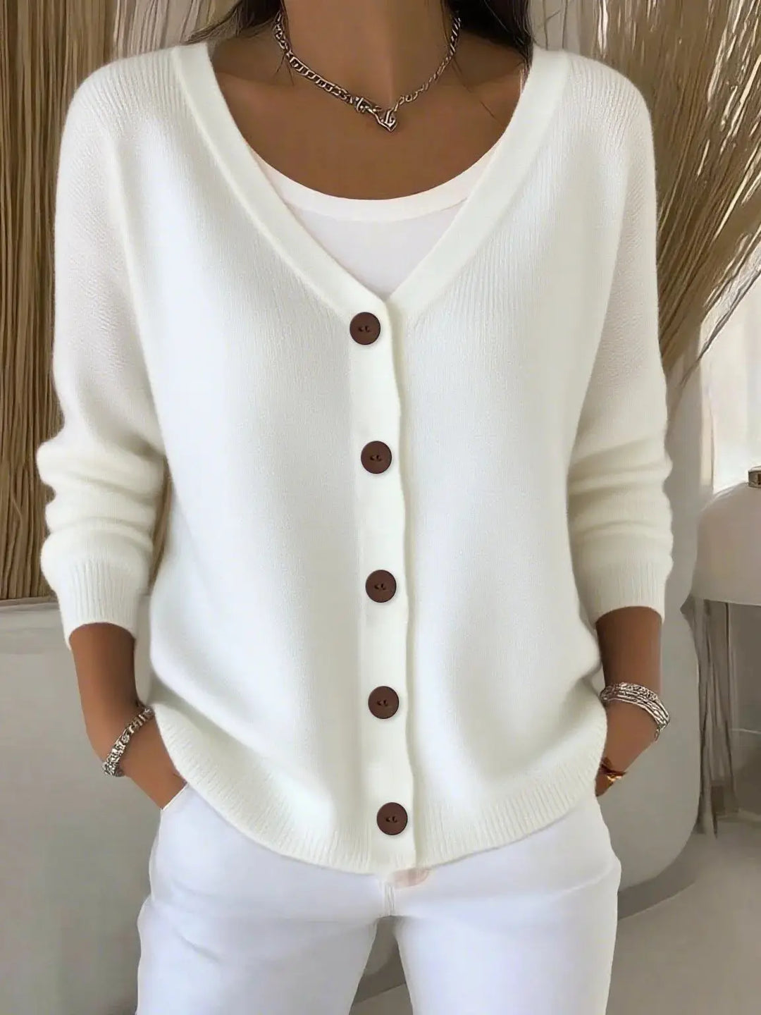 Woman wearing white button front knit cardigan
