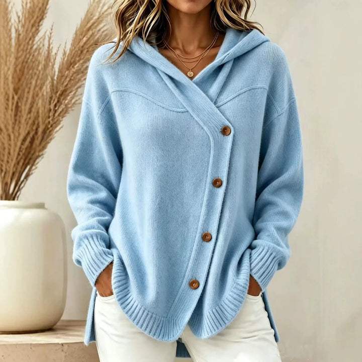 Woman wearing light blue hooded knit cardigan with asymmetric button placket