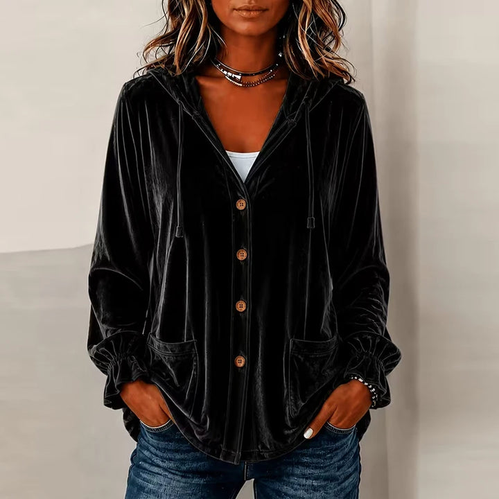Woman wearing black hooded velvet jacket with buttons