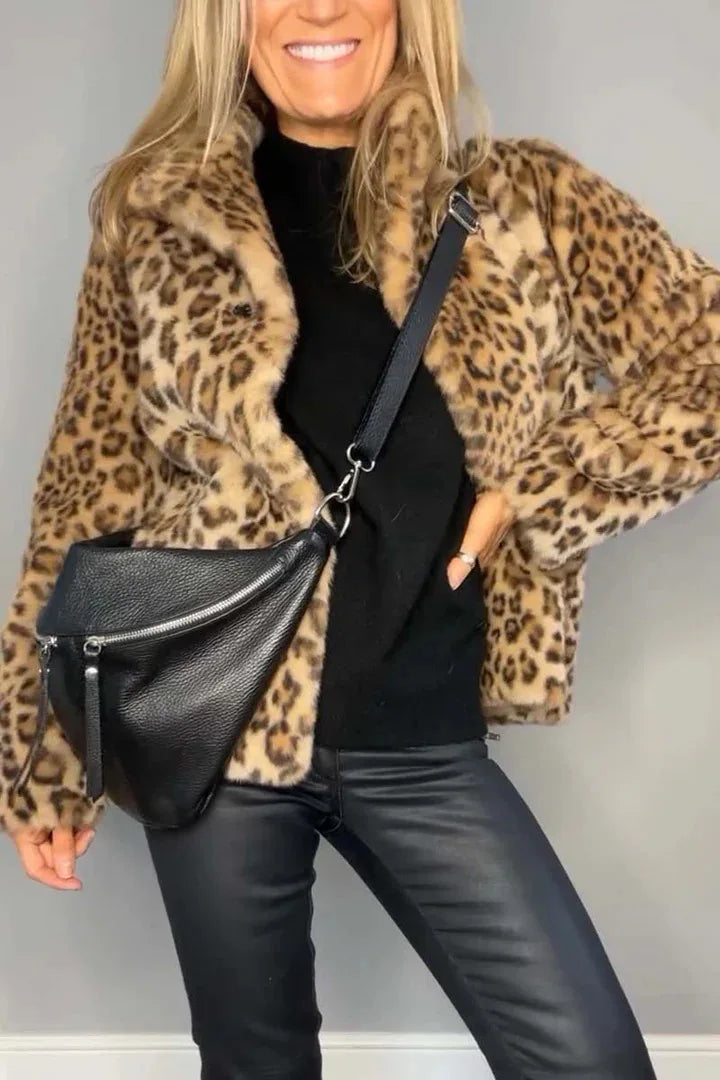 Model wearing leopard print faux fur coat with black bag