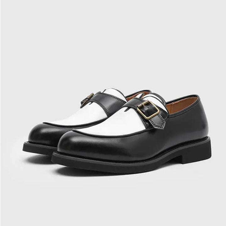Black and white two-tone loafers with buckle strap, three quarter view