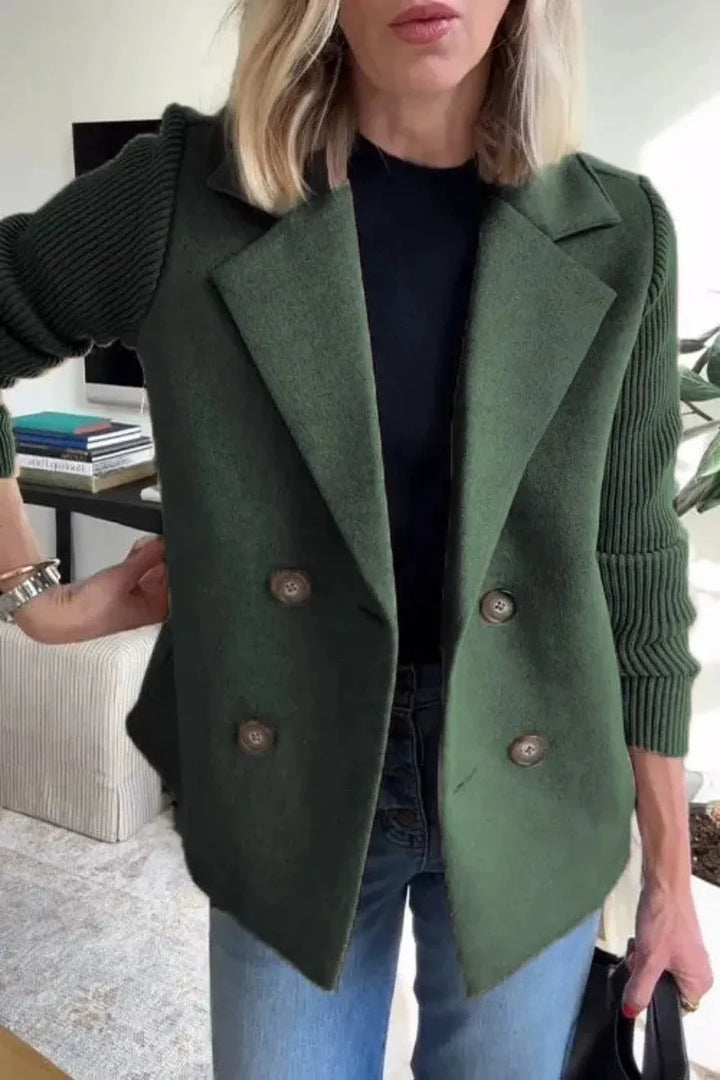 Woman wearing green double-breasted blazer with ribbed knit sleeves