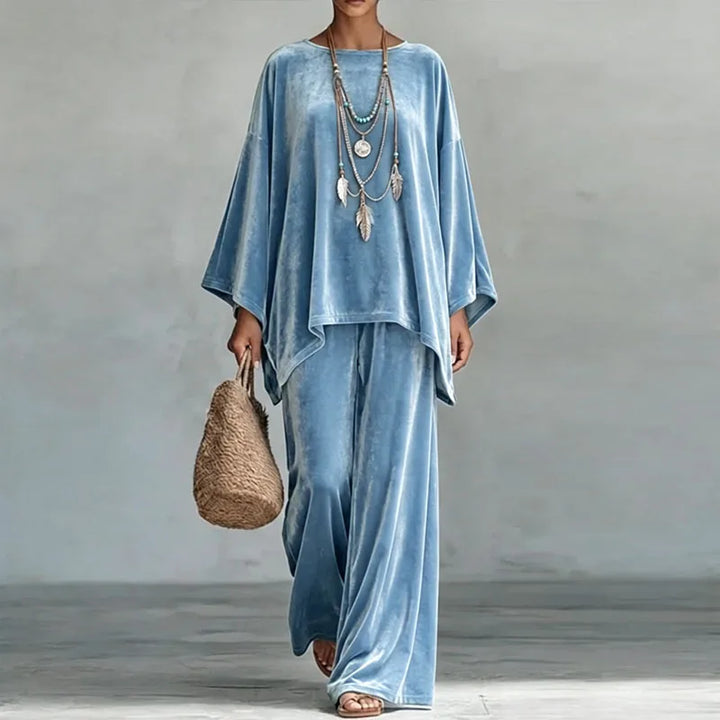 Woman wearing blue velvet batwing top and wide leg pants set, front view