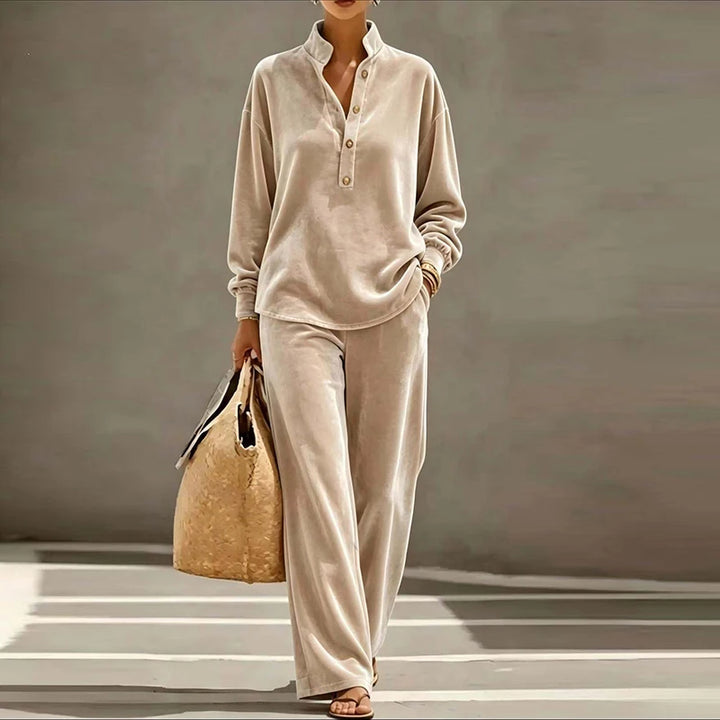 Woman wearing beige velvet stand collar top and wide leg pants set