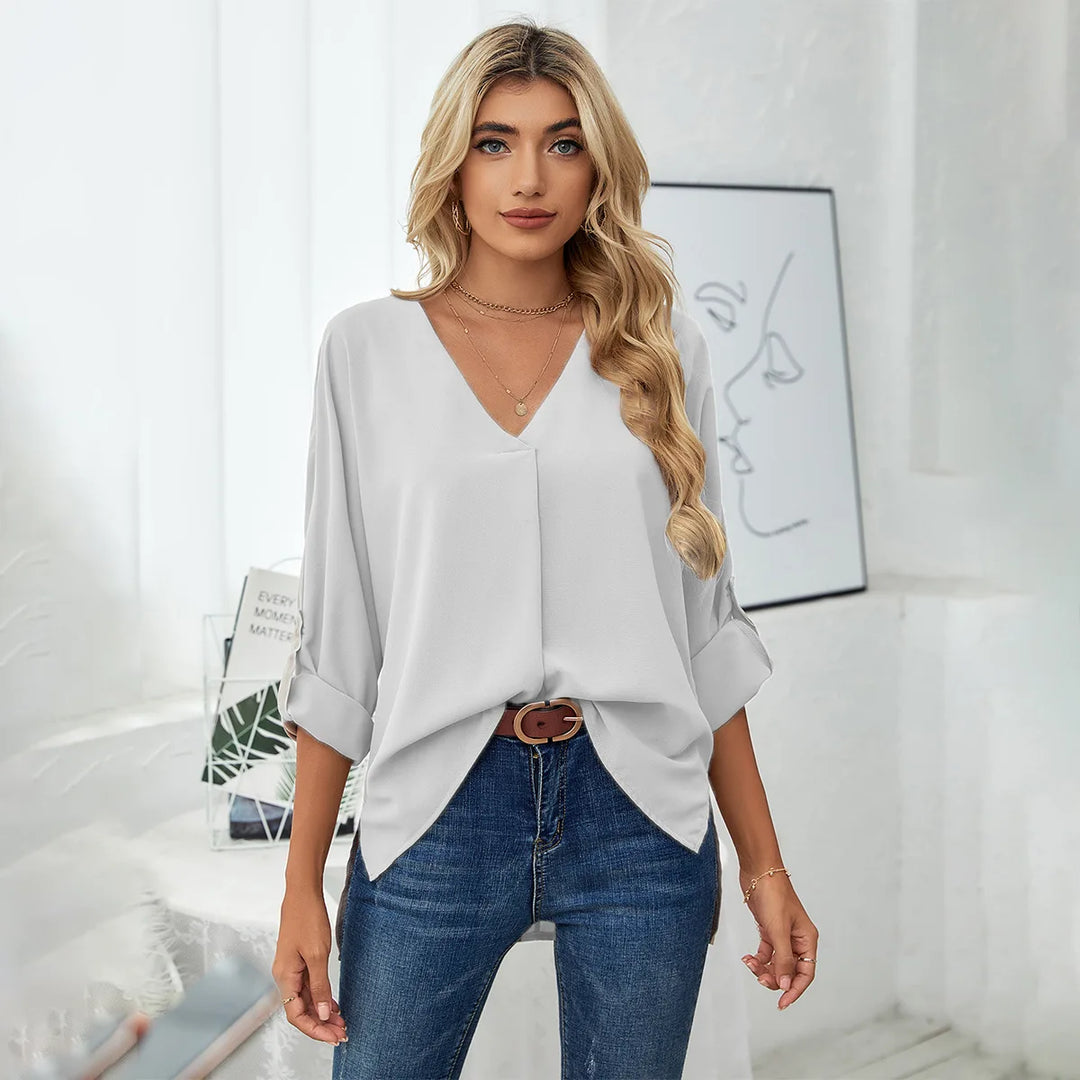 Front view of light gray pleated V-neck oversized blouse